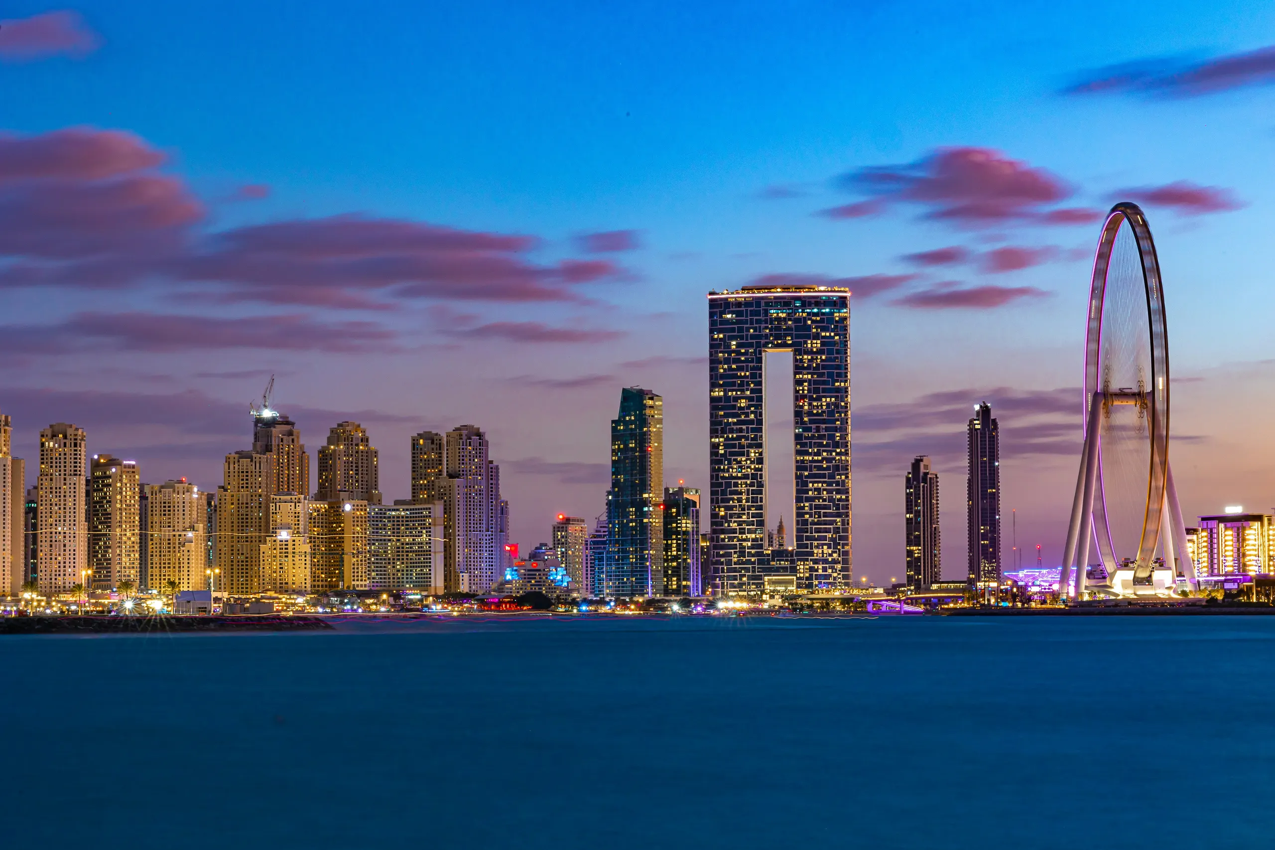 Dubai towers along the water at sunset